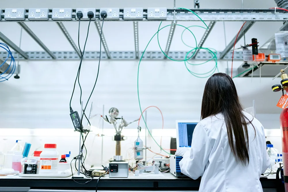 Researcher examining textile fiber samples in a testing laboratory